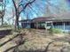 Exterior view of a home with a long attached carport featuring a lattice design, surrounded by nature at 922 Marshville Olive Branch Rd, Marshville, NC 28103