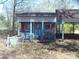 Charming playhouse with red shutters and white lattice trim, nestled in a green, tree-filled yard at 922 Marshville Olive Branch Rd, Marshville, NC 28103