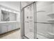 Bathroom featuring a large shower with glass doors and a double vanity at 10036 Brittondale Ln, Charlotte, NC 28215