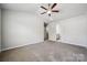 Spacious bedroom with ensuite bathroom and carpet flooring at 10036 Brittondale Ln, Charlotte, NC 28215