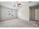 Bedroom featuring carpet, a ceiling fan, and a bright window with neighborhood views at 10036 Brittondale Ln, Charlotte, NC 28215