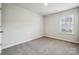 Bedroom with carpet, a window with blinds, and neutral wall color at 10036 Brittondale Ln, Charlotte, NC 28215