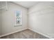 Walk-in closet with a window and metal shelving at 10036 Brittondale Ln, Charlotte, NC 28215
