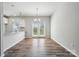 A well-lit dining area featuring modern lighting, wood-look floors, and glass doors to the outside at 10036 Brittondale Ln, Charlotte, NC 28215