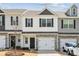 Charming two-story townhouse featuring a one-car garage and stone accents at 10036 Brittondale Ln, Charlotte, NC 28215