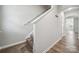 The hallway features neutral walls, wood-look floors, and a staircase with carpeted steps at 10036 Brittondale Ln, Charlotte, NC 28215