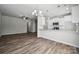 An open-concept kitchen with white cabinetry, stainless steel appliances, and a breakfast bar at 10036 Brittondale Ln, Charlotte, NC 28215