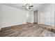 A spacious living room featuring a ceiling fan and seamless access to multiple rooms at 10036 Brittondale Ln, Charlotte, NC 28215