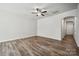 A spacious living room featuring a ceiling fan and seamless access to multiple rooms at 10036 Brittondale Ln, Charlotte, NC 28215