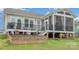 A full view of the home's backyard, including a screened porch, outdoor stairs, and a fire pit at 10421 Superb Ln, Charlotte, NC 28215