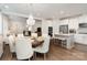 Inviting dining room featuring modern chandelier lighting, and an open view to the kitchen at 10421 Superb Ln, Charlotte, NC 28215