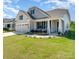 Beautiful home featuring a covered front porch, two-car garage, and landscaped front yard at 10421 Superb Ln, Charlotte, NC 28215