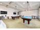 Community game room featuring two billiard tables, comfortable seating, and modern lighting at 10421 Superb Ln, Charlotte, NC 28215
