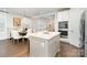 Open-concept kitchen with an island, seamlessly connecting to the dining and living areas at 10421 Superb Ln, Charlotte, NC 28215