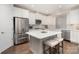 Modern kitchen with white cabinetry, stainless steel appliances, and center island with stool seating at 10421 Superb Ln, Charlotte, NC 28215