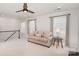 Comfortable upper living room featuring a cozy couch, and bright, natural lighting at 10421 Superb Ln, Charlotte, NC 28215