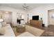 Bright and airy living room featuring hardwood floors, and a ceiling fan at 10421 Superb Ln, Charlotte, NC 28215