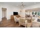 Bright and airy living room featuring hardwood floors, and an open view to the kitchen and dining room at 10421 Superb Ln, Charlotte, NC 28215