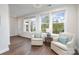 Comfortable living room featuring hardwood floors, serene natural light, and two plush chairs at 10421 Superb Ln, Charlotte, NC 28215