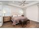 Cozy main bedroom featuring hardwood floors, large windows, and a comfortable bed at 10421 Superb Ln, Charlotte, NC 28215