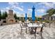 Community outdoor patio with tables, chairs, and an outdoor brick fireplace at 10421 Superb Ln, Charlotte, NC 28215