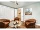 Inviting sitting room boasting three leather chairs, wood floors, and views into other rooms at 10421 Superb Ln, Charlotte, NC 28215