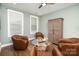 Stylish sitting room featuring a glass table, hardwood floors, and natural light at 10421 Superb Ln, Charlotte, NC 28215