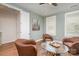 Comfortable sitting room featuring a glass table, hardwood floors, and natural light at 10421 Superb Ln, Charlotte, NC 28215