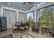 Relax in this sunroom, featuring a vaulted ceiling, neutral curtains, and a view of the backyard at 10421 Superb Ln, Charlotte, NC 28215