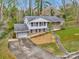 Aerial view of a traditional home with an attached garage nestled among mature trees at 107 Wedgewood Ne Cir, Concord, NC 28025