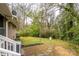 Large grassy backyard with a stone walkway and mature trees, perfect for outdoor activities at 107 Wedgewood Ne Cir, Concord, NC 28025