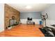 This is a large basement area with a fireplace, television and exercise equipment at 107 Wedgewood Ne Cir, Concord, NC 28025