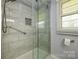 This bathroom features a walk-in shower with built in shelving and a shower seat at 107 Wedgewood Ne Cir, Concord, NC 28025