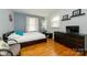 This bedroom features hardwood flooring, dresser, and bright natural lighting at 107 Wedgewood Ne Cir, Concord, NC 28025