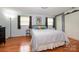 Bedroom with hardwood floors, a comfortable bed, and warm natural light filtering through the windows at 107 Wedgewood Ne Cir, Concord, NC 28025