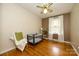 This bedroom features hardwood flooring, a ceiling fan, and bright natural lighting at 107 Wedgewood Ne Cir, Concord, NC 28025