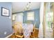 This cozy dining area includes table, chairs, lighting, and access to an outdoor deck at 107 Wedgewood Ne Cir, Concord, NC 28025