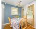 This cozy dining area includes table, chairs, lighting, and access to an outdoor deck at 107 Wedgewood Ne Cir, Concord, NC 28025