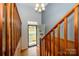 View of front door, wooden stairs, and wood paneling in a naturally lit foyer at 107 Wedgewood Ne Cir, Concord, NC 28025