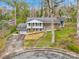 Charming two-story home featuring a brick and white facade, attached garage, and mature trees at 107 Wedgewood Ne Cir, Concord, NC 28025