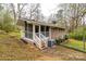 Rear view of the home featuring a screened in porch and well maintained lawn at 107 Wedgewood Ne Cir, Concord, NC 28025