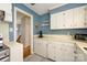Traditional kitchen with white cabinets, blue walls, and modern appliances at 107 Wedgewood Ne Cir, Concord, NC 28025
