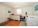 Functional laundry area featuring a washer, dryer, storage cabinets and hardwood floors at 107 Wedgewood Ne Cir, Concord, NC 28025