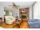 Hardwood floors, fireplace, and neutral colored furniture in an open living area at 107 Wedgewood Ne Cir, Concord, NC 28025