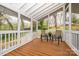 Inviting screened porch with wooden flooring, seating, and a view of the surrounding greenery at 107 Wedgewood Ne Cir, Concord, NC 28025