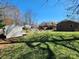Backyard featuring an in-ground pool, storage shed, garden area, and brick house at 1301 Huckleberry Dr, Lincolnton, NC 28092