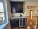 This bar area features a wine fridge, granite counters and storage making it perfect for entertaining at 1301 Huckleberry Dr, Lincolnton, NC 28092