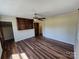 Spacious bedroom with hardwood floors, ceiling fan, and custom shelving at 1301 Huckleberry Dr, Lincolnton, NC 28092