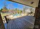 Exterior view from covered deck with wood railing overlooking backyard pool and lush green trees at 1301 Huckleberry Dr, Lincolnton, NC 28092
