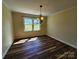 Inviting dining room featuring hardwood floors, natural light, and a stylish chandelier at 1301 Huckleberry Dr, Lincolnton, NC 28092